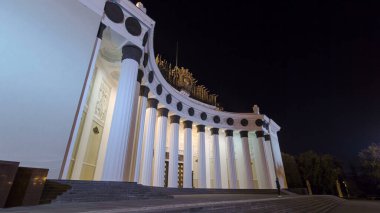 Central Pavilion of VDNH VDNKh exhibition at night in Moscow. Russia. Timelapse and hyperlapse. Front view with illuminated columns