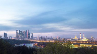 Panoramic view of Moscow City, Russia, from Sparrow Hills day to night transition timelapse from above. Cloudy colorful sky over skyscrapers
