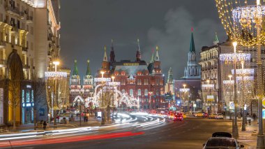 Timelapse of the festive Tverskaya Street with wineglass-shaped street lamps on a frosty winter night, featuring traffic and the Historical Museum in the background. Moscow, Russia. clipart