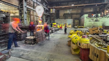 The liquid metal is poured into molds at the metallurgical plant timelapse hyperlapse. Worker controlling metal melting in furnaces. Factory workshop with steelmaking furnace