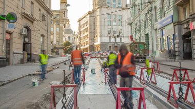 Kurulum aşamasındaki tramvay rayları ve zaman ayarlı özel cihazlarla beton plakalara entegrasyon. Tramvay raylarının yeniden inşası