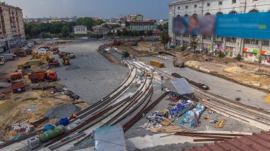 Laying of new tram rails on a city street. Repair works on the street aerial panoramic timelapse. Installation of new modern railway rails for trams. Reconstruction of tram tracks on intersection