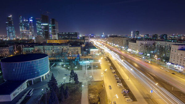 Skyscrapers International Business Center City in a distance at night with busy traffic on the road avenue aerial timelapse from top, Moscow, Russia