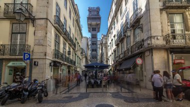 Santa Justa Elevator timelapse hyperlapse in Lisbon, Portugal. Blue sky on background. Connecting downtown to Bairro Alto. Historic buildings an a walking streets