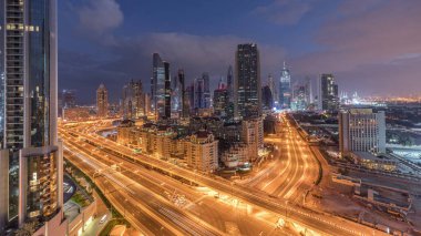 Sheikh Zayed Yolu ve DIFC binalarının Skyline görüntüsü Dubai, BAE 'deki geçiş zamanı. Finansal merkezdeki aydınlık gökdelenler şehir merkezinin yukarısından gökyüzü manzarası