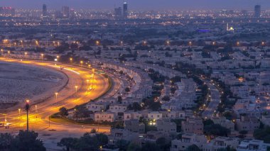 Aerial view to villas and houses near Golf course night to day transition timelapse. Traffic on intersection. Hazy morning before sunrise clipart