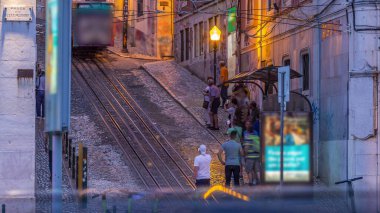 Lisbon's Gloria funicular day to night transition timelapse located on the west side of the Avenida da Liberdade connects downtown with Bairro Alto. It's classified as a national monument opened 1885 clipart