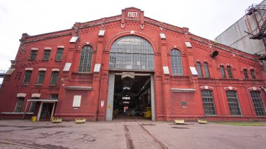 The old factory bricks building with windows and gates timelapse hyperlapse. Front view of historic workshop building in industrial area of big plant