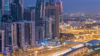 Dubai Yat Limanı gökdelenler hava üstten görünüm güneş doğmadan önce Jlt gelen Dubai gece gün timelapse, Birleşik Arap Emirlikleri için. Işıklı modern kuleleri ve Şeyh zayed yolu üzerinde trafik.