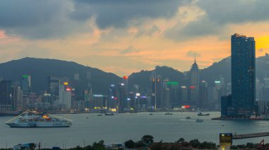 Hong Kong 'dan gece geçişi, Kowloon Körfezi' nden hava görüntüsü şehir merkezindeki zaman dilimi büyük gemi ve çatıdaki kuleler.