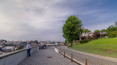 Monastery da Serra do Pilar in Vila Nova de Gaia and Dom Luiz bridge timelapse hyperlapse from park, Porto, Portugal. Famous fridge on the left