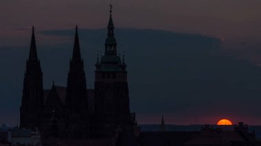 Güneşin doğuşundaki Prag manzarası sisli bir sabah saatinde. Solda Prag Kalesi ve St. Vitus Katedrali ve bulutlarda yükselen altın bir güneş. Görüntüyü kapat