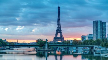 Eyfel Kulesi, Seine Nehri 'nde ve Fransa' nın Paris şehrinde teknelerle gün doğumu zamanı. Mirabeau Köprüsü 'nden görüntü. Modern binalar ve Özgürlük Anıtı. Dramatik gökyüzü