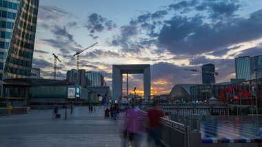 Skyscrapers of La Defense timelapse hyperlapse at sunset - Modern business and residential area in the near suburbs of Paris, France. Orange dramatic sky before sunset