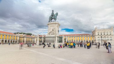 Bronze statue of King Jose I and triumphal arch at Rua Augusta at Commerce square timelapse hyperlapse in Lisbon, Portugal. Cloudy sky. Walking area