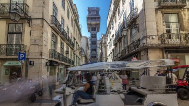 Santa Justa Elevator timelapse hyperlapse in Lisbon, Portugal. Blue sky on background. Connecting downtown to Bairro Alto. Historic buildings an a walking streets