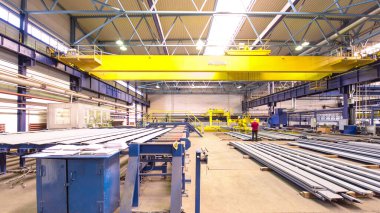 Factory workshop with lifting crane device timelapse hyperlapse, lift operator loads using lifting magnet, mechanical workshop, metal structures plant. Automated machine for precise metal cutting.