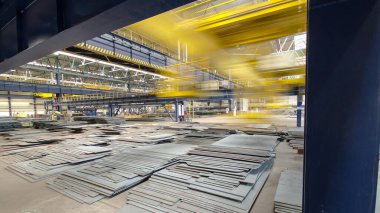 Factory workshop with lifting crane device timelapse hyperlapse, lift loads using lifting magnet, mechanical workshop, metal sheets structures on the floor of plant.