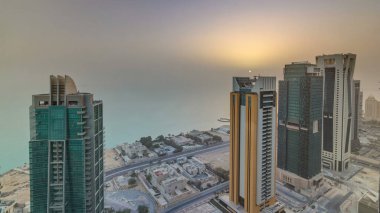 The skyline of West Bay and Doha City Center during sunrise timelapse, Qatar. Modern skyscrapers and traffic on the road. Gulf on background clipart