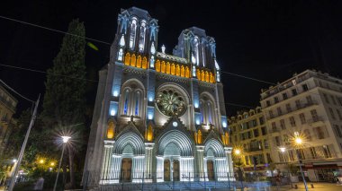 Basilique Notre-Dame de l Assomption at night located on Avenue Jean Medecin hyperlapse in Nice, France. Nice is the fifth most populous city in France and the capital of Alpes-Maritimes departement clipart