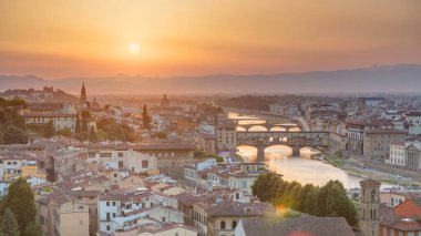 Skyline view of Arno River aerial timelapse from above. Ponte Vecchio from Piazzale Michelangelo at Sunset, Florence, Italy. Colorful sky. Evening mist clipart