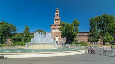 Sforza Kalesi - Castello Sforzesco'ya ve çeşmenin önündeki ana girişe timelapse hyperlapse, Milan, İtalya. Yaz günü mavi gökyüzü. Etrafta dolaşan insanlar