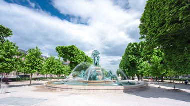 The fountain of the Observatory or La fontaine de l'Observatoire timelapse hyperlapse. Fountain Four continents in the Jardin Marco Polo, south of the Jardin du Luxembourg in Paris, France clipart