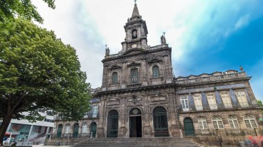 The Trinity Church front view timelapse hyperlapse with cloudy sky and fountain on square in Porto, Portugal. Porto is one of the most popular tourist destinations in Europe.