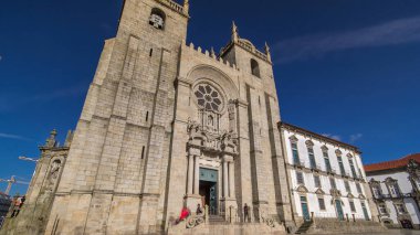 Porto Cathedral or Se Catedral do Porto timelapse hyperlapse front view with blue sky at sunny day. Romanesque and Gothic architecture.