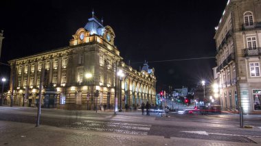 The crossroads with the illuminated Sao Bento Railway Station night timelapse hyperlapse. The building of station is a popular tourist attraction of Europe.