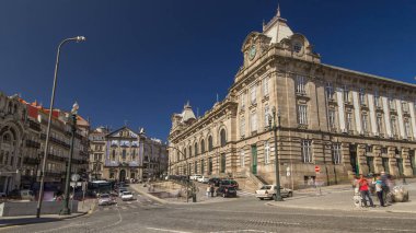 Traffic on Almeida Garret Square with the Sao Bento railway station and Congregados Church at the back timelapse hyperlapse, Porto, Portugal. Blue sky