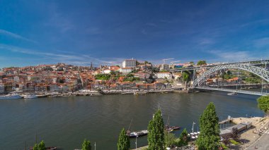 Old colorful houses in old part of Porto and waterfront, aerial view from cabine of cable car over Douro river from the Dom Luiz bridge timelapse hyperlapse