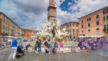Piazza Navona, the fountain of four rivers timelapse hyperlapse. People sitting around. Cloudy sky. Italy, Rome