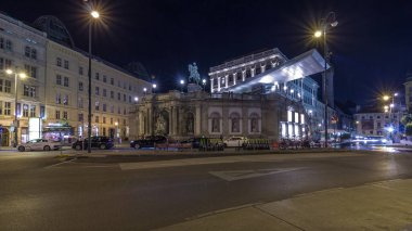 Night view of equestrian statue of Archduke Albert in front of the Albertina Museum timelapse hyperlapse in Vienna, Austria. Illuminated buildings on a background clipart