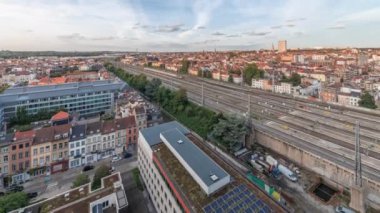 Brüksel Kuzey İstasyonu 'nun tren rayları, gelen ve giden trenlerle dolu. Schaerbeek akşam şehir manzarası kırmızı çatılar, sanayi bölgeleri ve bulutlu bir gökyüzü. Belçika