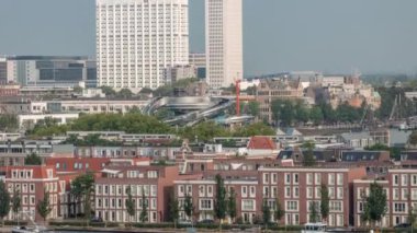 Rotterdam, Hollanda 'daki Katendrecht Yarımadası ve Maashaven Limanı' nın panoramik zaman çizelgesi. Şehir sabahları ufuk çizgisi, modern kuleler, inşaat alanı ve geleneksel sahil evleri