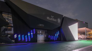 Abu Dhabi, UAE - Feb 25, 2023: International Defence Exhibition and Conference IDEX day to night timelapse hyperlapse. Strategically important tri-service exhibition. Tawazun Council pavilion screen clipart