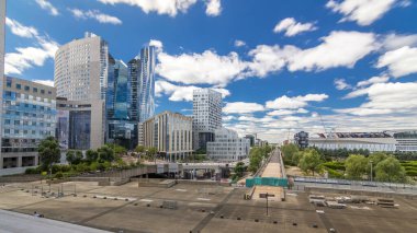 Skyscrapers of Defense timelapse hyperlapse modern business and financial district in Paris with highrise buildings. View from Grande Arche. Blue cloudy sky and reflections in modern towers. clipart