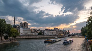 Notre Dame de Paris with Le Pont D'Arcole bridge after sunset day to night transition timelapse, Paris, France, Europe. People and boats. Colorful sky at summer day with reflection on river Seine clipart