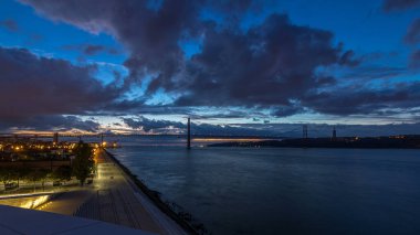 Lisbon city before sunrise with April 25 bridge night to day transition panoramic timelapse, Cristo Rei and waterfront early morning