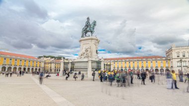 Bronze statue of King Jose I and triumphal arch at Rua Augusta at Commerce square timelapse hyperlapse in Lisbon, Portugal. Cloudy sky. Walking area