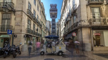 Santa Justa Elevator timelapse hyperlapse in Lisbon, Portugal. Blue sky on background. Connecting downtown to Bairro Alto. Historic buildings an a walking streets