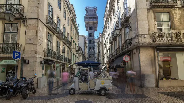 Santa Justa Elevator timelapse hyperlapse in Lisbon, Portugal. Blue sky on background. Connecting downtown to Bairro Alto. Historic buildings an a walking streets