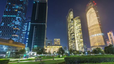 Abu Dabi 'deki gökdelenler gece vakti gökdelenler hiperhızlandırılmış, Birleşik Arap Emirlikleri. Aydınlatılmış modern kulelerle Corniche 'den görüntü