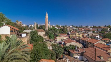 Red tile roofs of the Antalya Old Town timelapse hyperlapse, Turkey, with Yivli Minaret, Clock Tower and Tekeli Mehmet Pasa mosque. Blue sky at summer day clipart