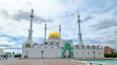 Exterior of the Nur Astana mosque timelapse hyperlapse with blue cloudy sky in Nur-Sultan city, Kazakhstan. This mosque is the second largest in Kazakhstan. clipart