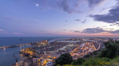 Day to Night Transition Timelapse of Seaport and Loading Docks at Barcelona's Port. Aerial Top View from Montjuic Hill, Illuminating the Scene with the City Lights After Sunset clipart