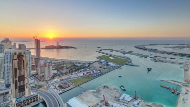 JBR and Bluewaters island at sunset aerial timelapse. Modern towers and skyscrapers, traffic on the bridge and part of palm jumeirah island clipart