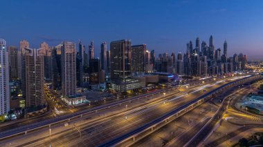 Dubai Yat Limanı gökdelenler hava üstten görünüm güneş doğmadan önce Jlt gelen Dubai gece gün timelapse, Birleşik Arap Emirlikleri için. Işıklı modern kuleleri ve Şeyh zayed yolu üzerinde trafik.
