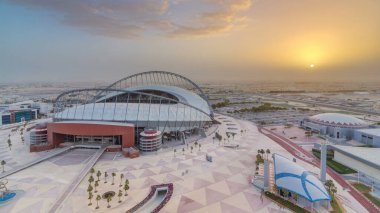 Doha 'da güneş doğarken Aspire Bölgesi' nin havadan görüntüsü. Yollarda ve araba parklarında trafik vardı. Sisli hava